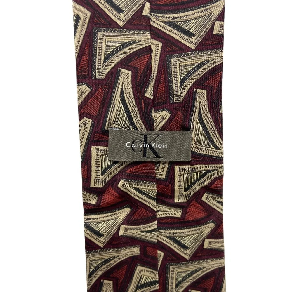 Calvin Klein Burgundy, Black and Tan Abstract Design Necktie.